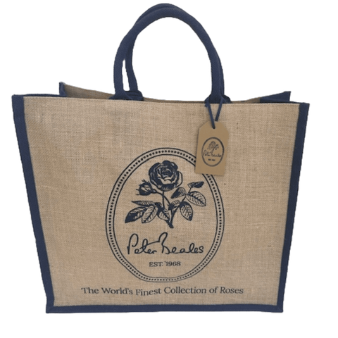 Beige jute shopping bag with navy handles and round rose emblem logo