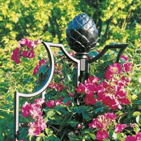 Black wrought-iron rose obelisk with tall central finial and curved side scrolls